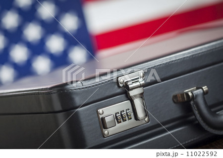 Leather Briefcase Resting on Table with American Flag Behind Leather Briefcase Resting on Table with American Flag Behind 11022592