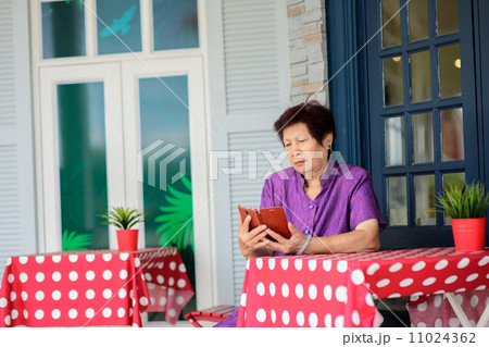 Happy elderly woman selfie herself with her smart phone Happy elderly woman selfie herself with her smart phone 11024362
