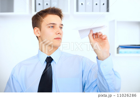 Young businessman launch a paper airplane 11026286