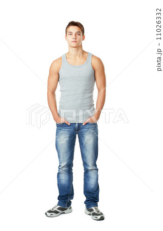 young man standing with hands in pockets 11026332