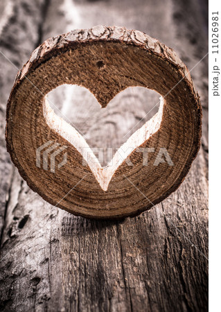Light  heart on rustic wooden background 11026981