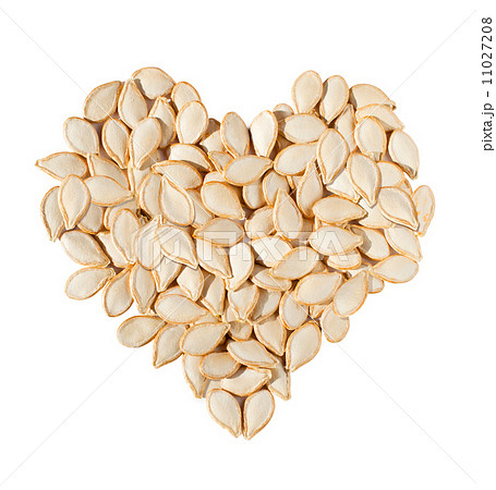 Heart from pumpkin seeds isolated on white background Heart from pumpkin seeds isolated on white background 11027208