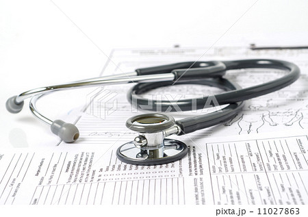 stethoscope resting on a sheet of medical lab test results 11027863