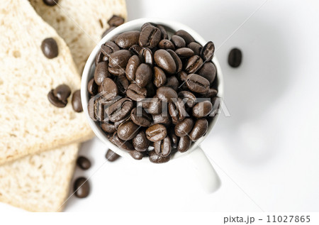 A close up shot of coffee beans in coffee cup and bread  11027865