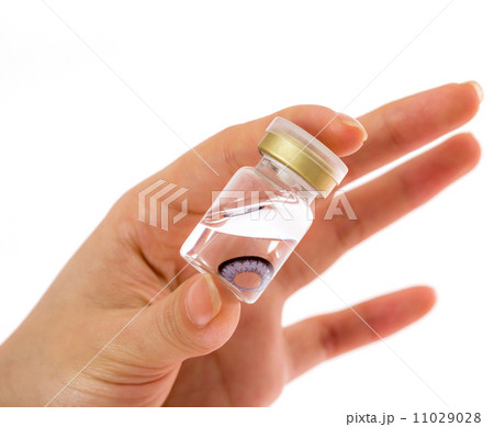 cosmetic contact lenses in bottle with hand cosmetic contact lenses in bottle with hand 11029028