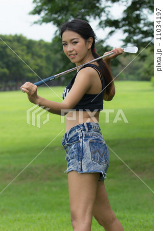 Asian woman holding a golf Asian woman holding a golf 11034197