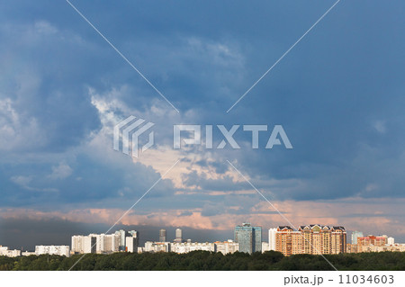 dark blue rainy clouds in sunset sky over city dark blue rainy clouds in sunset sky over city 11034603