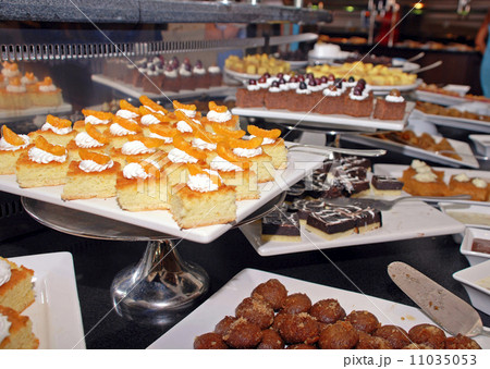 Dessert bar with assorted fruit and chocolate sweets. 11035053