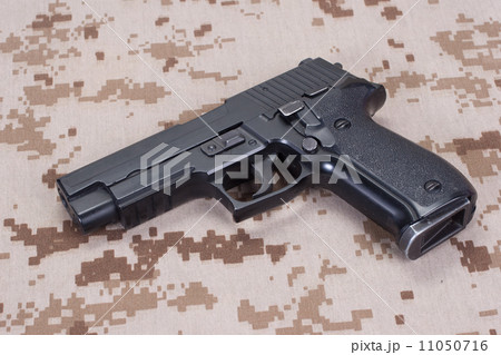 US MARINES concept with handgun on camouflage uniform 11050716