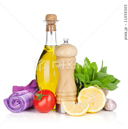 Fresh herbs, tomato, olive oil and pepper shaker Fresh herbs, tomato, olive oil and pepper shaker 11056305