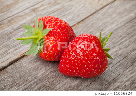 Ripe strawberries over wooden table background 11056324