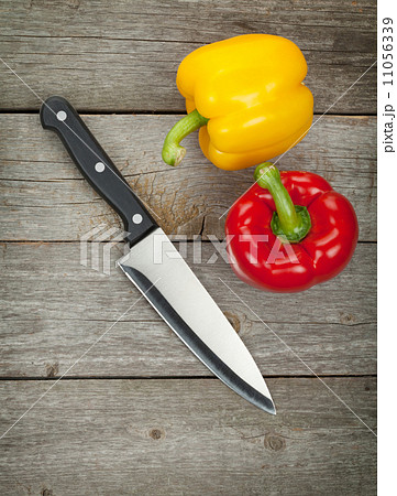 Colorful bell peppers and kitchen knife 11056339