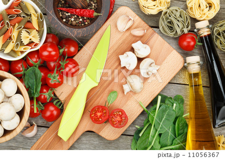 Fresh ingredients for cooking: pasta, tomato, mushroom and spice 11056367