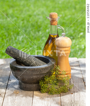 Olive oil bottle, pepper shaker and mortar Olive oil bottle, pepper shaker and mortar 11056462
