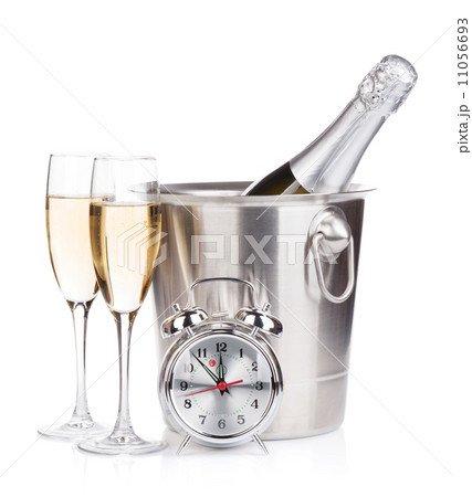 Champagne bottle in bucket, two glasses and alarm clock 11056693