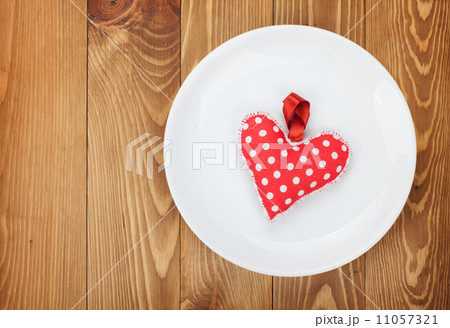 Valentine's Day toy heart over plate 11057321