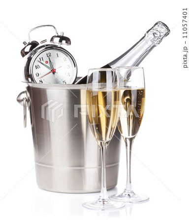 Champagne bottle in bucket, two glasses and alarm clock 11057401