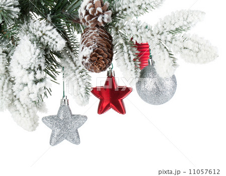 Fir tree branch with christmas decor covered with snow 11057612