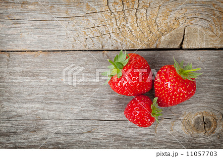 Ripe strawberries over wooden table background 11057703