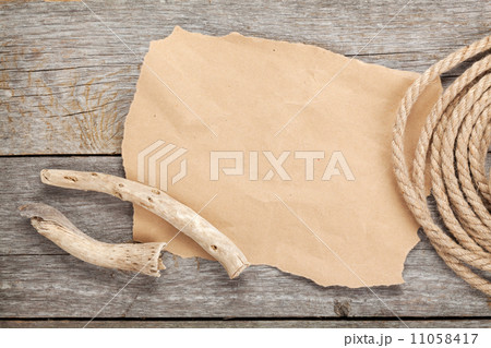 Old paper and rope on wooden textured background Old paper and rope on wooden textured background 11058417