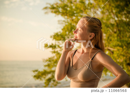 Woman watching sunset Woman watching sunset 11066568