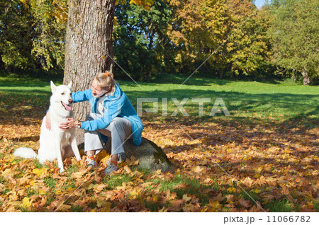 The woman with a dog in autumn park The woman with a dog in autumn park 11066782