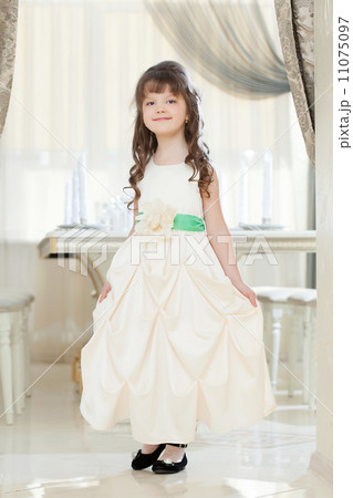 Image of smiling girl posing in long smart dress Image of smiling girl posing in long smart dress 11075097