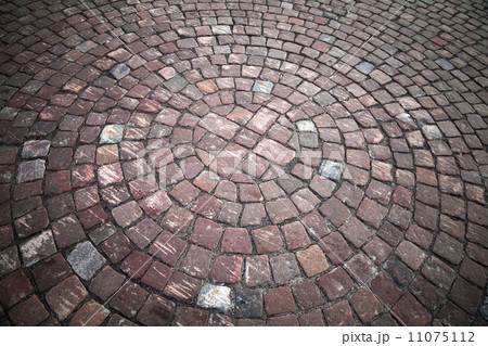 Round element of granite cobblestone road. Background texture 11075112