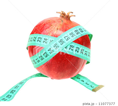 Measure tape on red pomegranate Measure tape on red pomegranate 11077377
