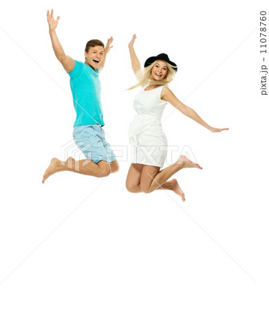 Beautiful smiling young couple jumping isolated on white 11078760
