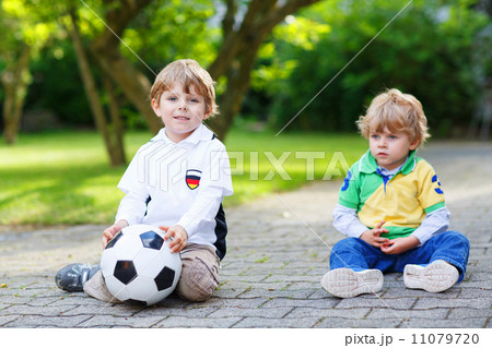Two little fan boys at public viewing of football game 11079720