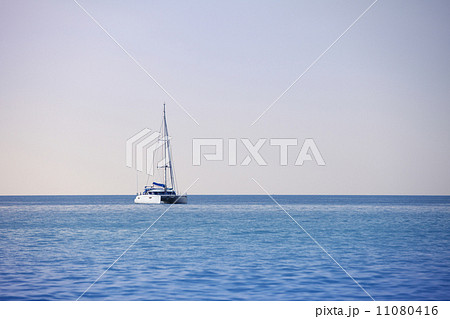 White sailing catamaran on calm sea 11080416