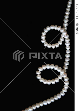 White pearls on the black silk as background White pearls on the black silk as background 11080624