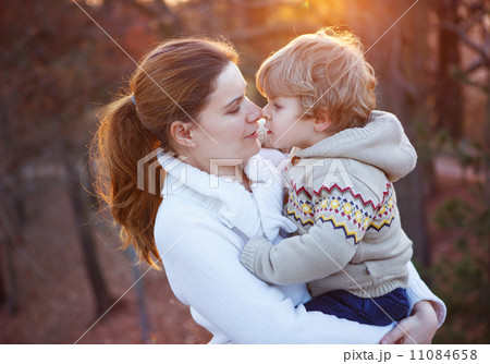 Mother and little son in park or forest, outdoors. 11084658