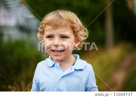 Beautiful little boy walking on a country road Beautiful little boy walking on a country road 11084737