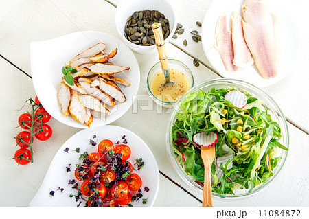 Salad with grilled meat, smoked fish and different vegetables. 11084872