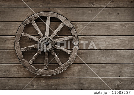 Old wagon wheel on wooden wall Old wagon wheel on wooden wall 11088257