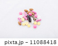 many colorful pills on a white background. symbolic photo for medicine and drugs 11088418