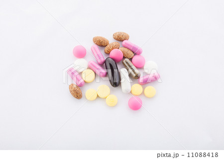many colorful pills on a white background. symbolic photo for medicine and drugs many colorful pills on a white background. symbolic photo for medicine and drugs 11088418