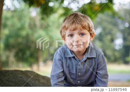 Little blond boy of three years in autumn forest. Little blond boy of three years in autumn forest. 11097540