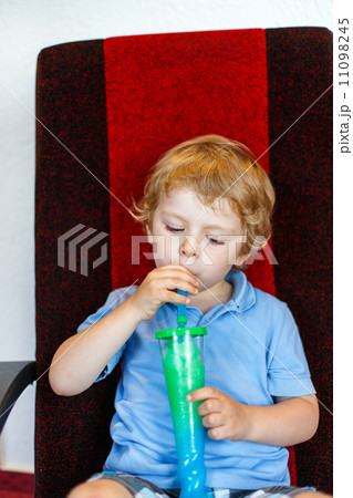 Little boy drinking colorful frozen slush ice Little boy drinking colorful frozen slush ice 11098245