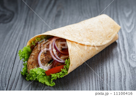 tasty fresh wrap sandwich with chicken and vegetables 11100416