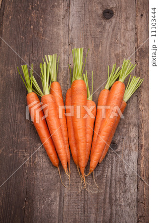 fresh carrot bunch on grungy wooden background 11103444