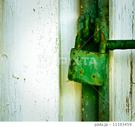 old green rusty iron padlock 11103459
