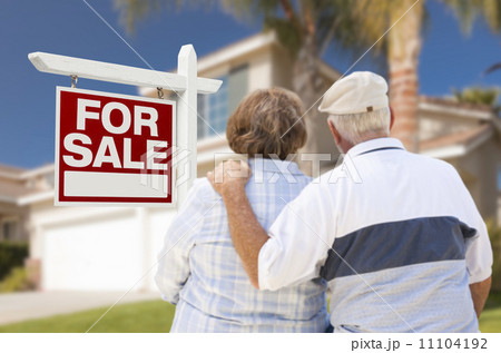 Happy Senior Couple Front of For Sale Sign and House Happy Senior Couple Front of For Sale Sign and House 11104192