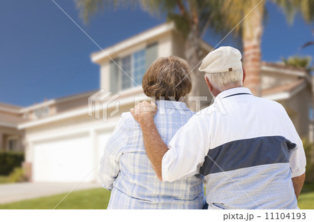 Happy Senior Couple Looking at Front of House Happy Senior Couple Looking at Front of House 11104193