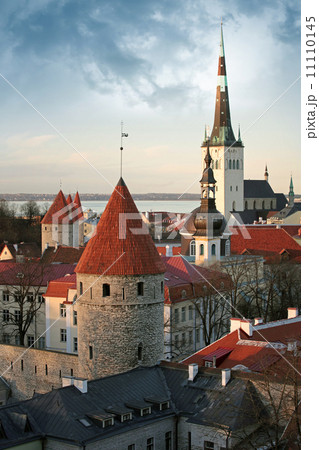 Old town of Tallinn. Houses, fortress towers with red roofs and church St. Olaf Old town of Tallinn. Houses, fortress towers with red roofs and church St. Olaf 11110145