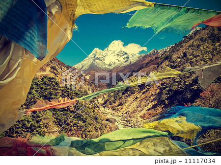 Prayers flags in Himalaya mountains, Nepal, vintage retro style. 11117034