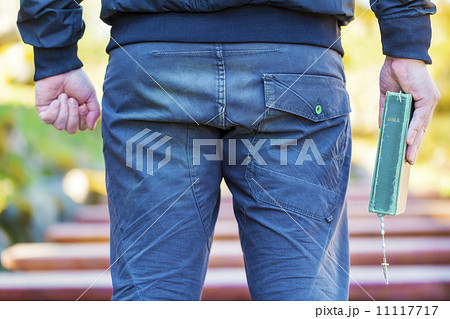 Religious man with Holy Bible and Rosary 11117717