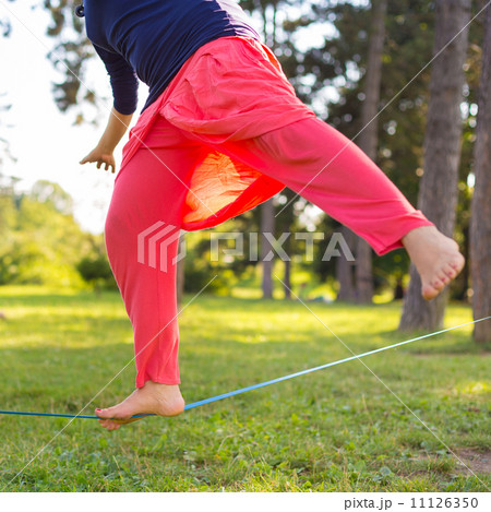 Slack line in the city park. Slack line in the city park. 11126350